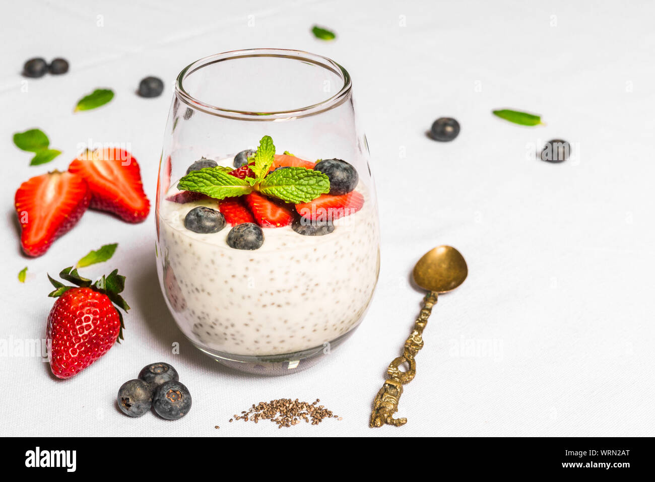 Breakfast yoghurt with chia seeds against white background Stock Photo