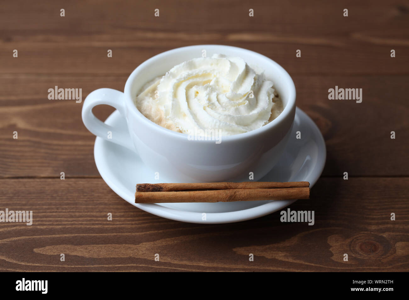 viennese coffee with whipped cream isolated on wooden table Stock Photo