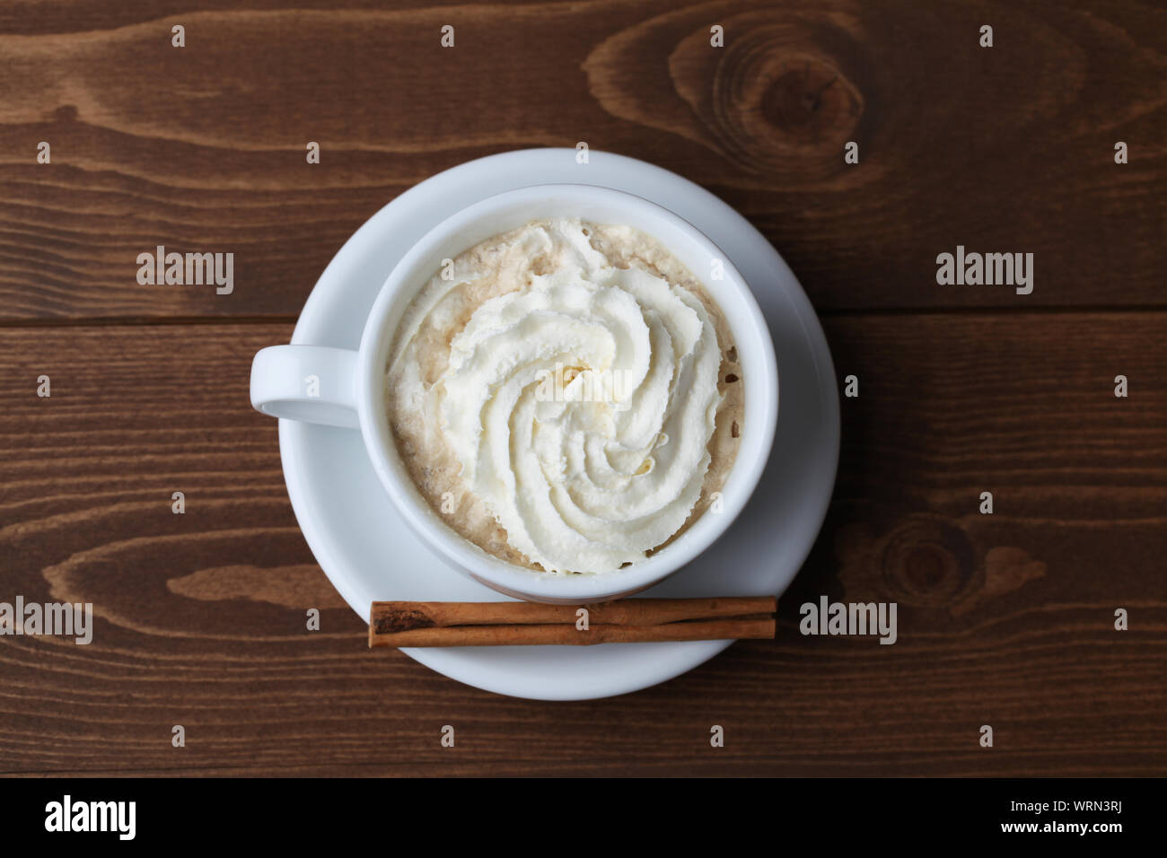 viennese coffee with whipped cream isolated on wooden table Stock Photo