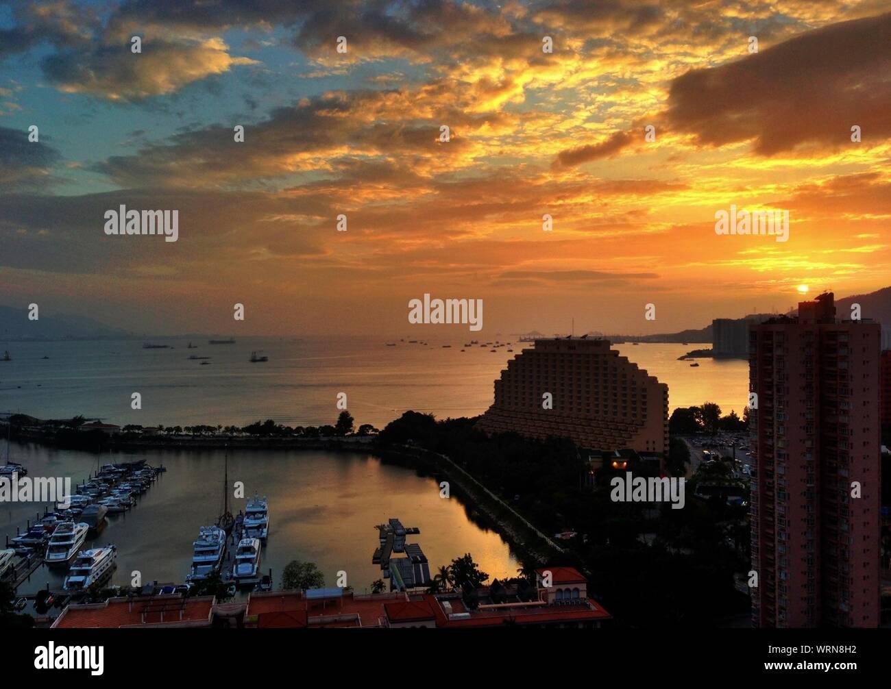 View Of Hong Kong Gold Coast Hotel And Harbor At Sunset Stock Photo