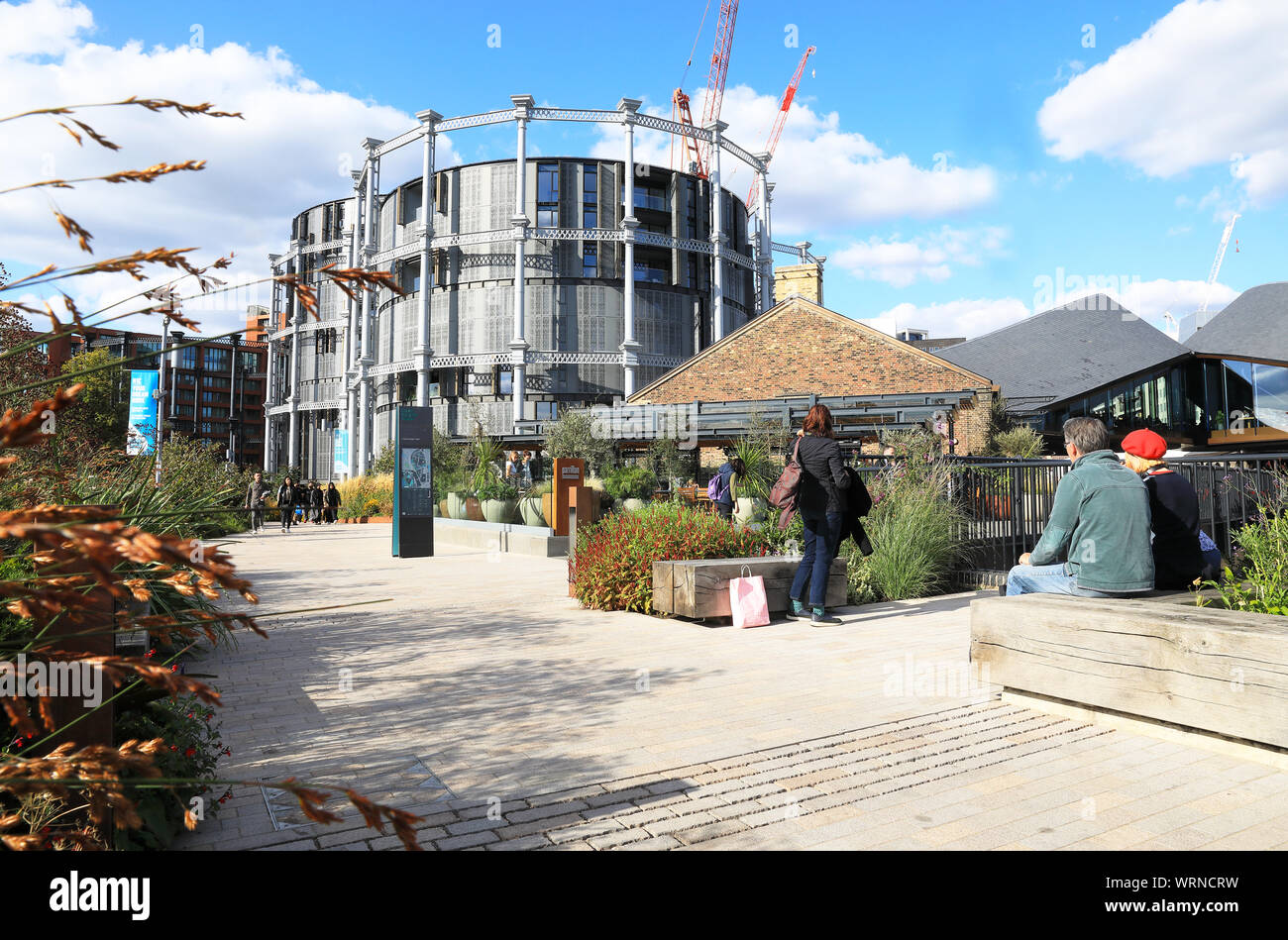 The Gasholder apartments and landscaped walkway at Coal Drops Yard, at Kings Cross, in north