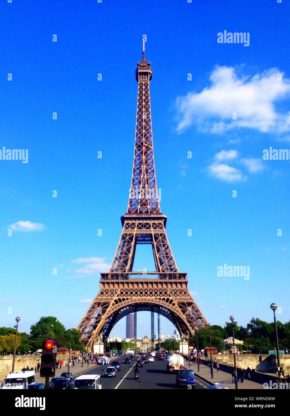 Eiffel Tower Dominating Over Street Stock Photo