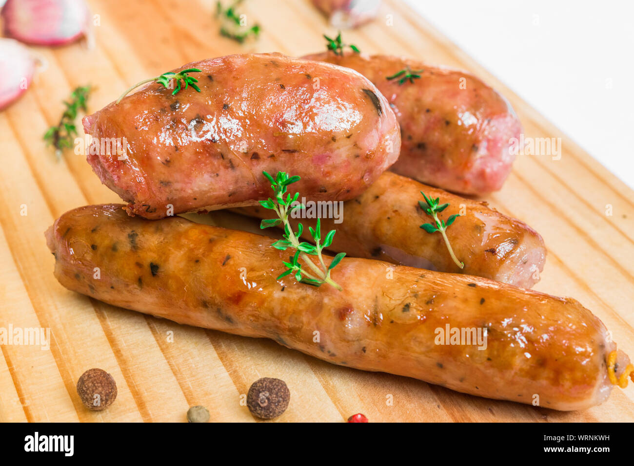 Grilled barbecue chorizo meat sausages on a wooden board. Stock Photo