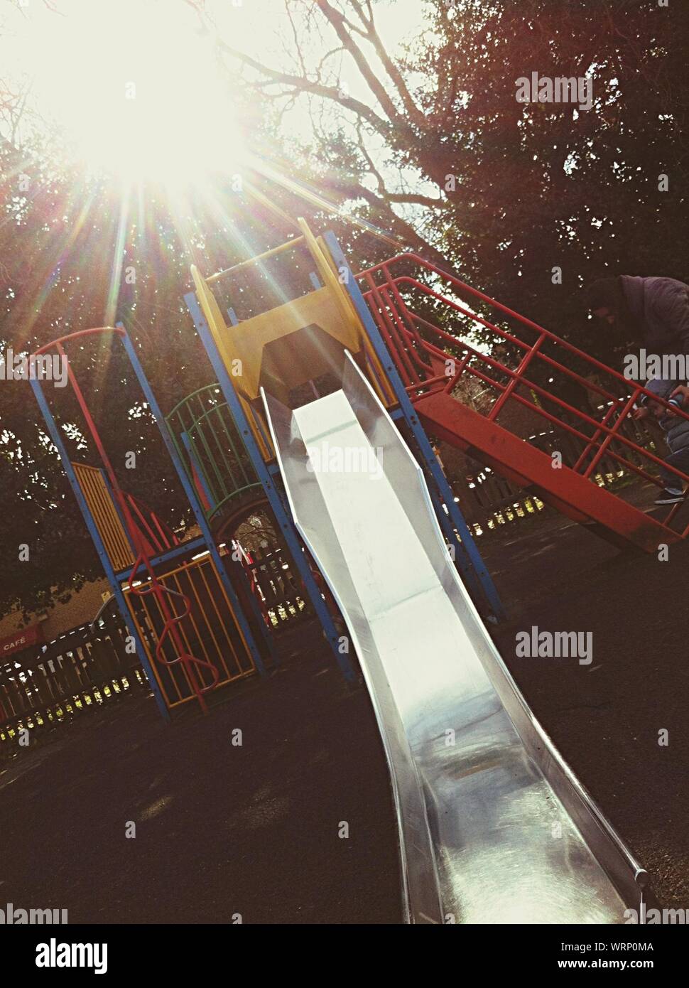 Sunlight Beaming On Slide At Park Stock Photo