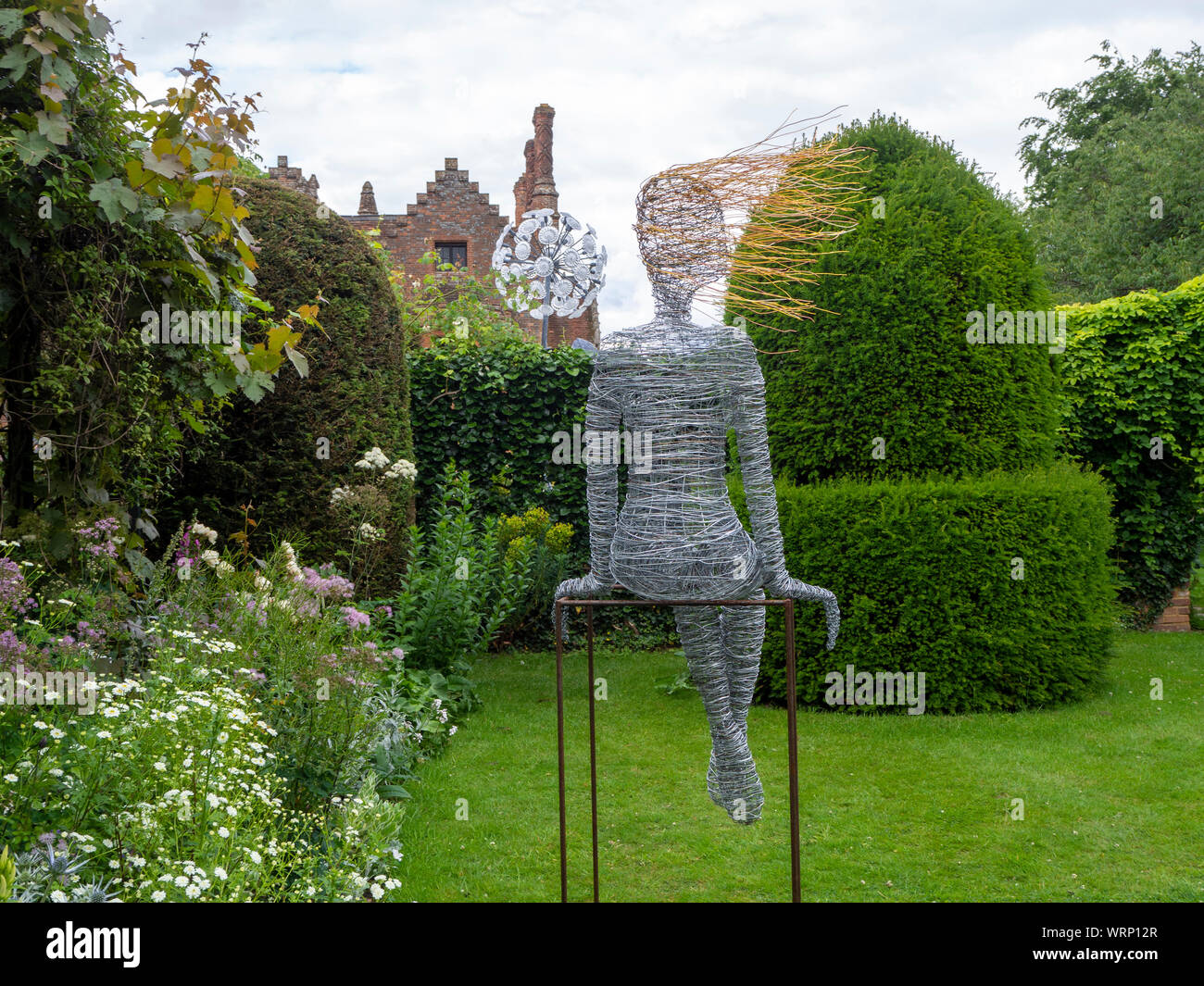 Chenies Manor from the topiary garden. Sculptures by Jenny Pickford, Dandelion, and Rachel Ducker's wirework..marhueri Stock Photo