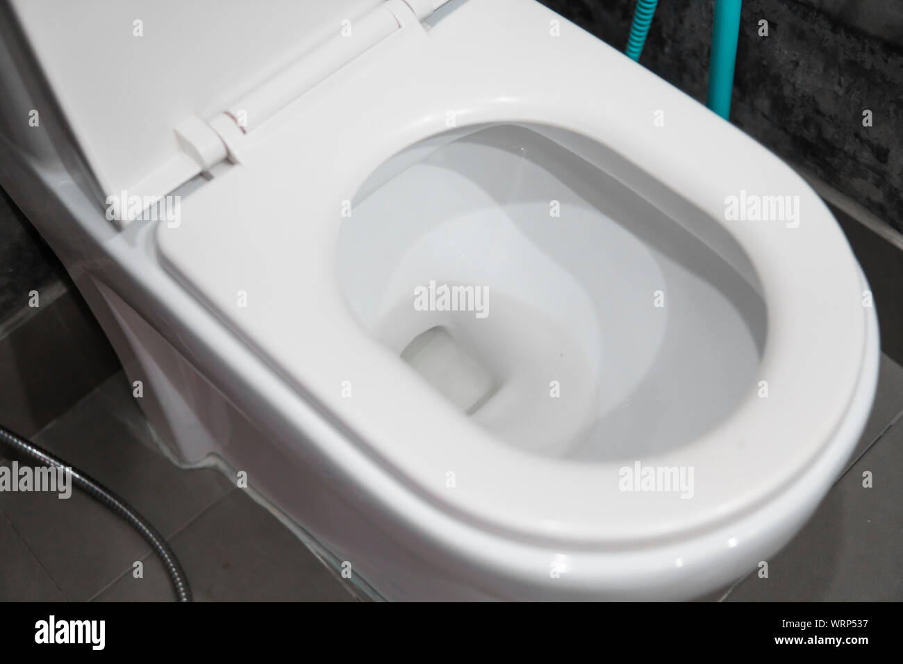 White hanging toilet seat on white toilet in the home bathroom with