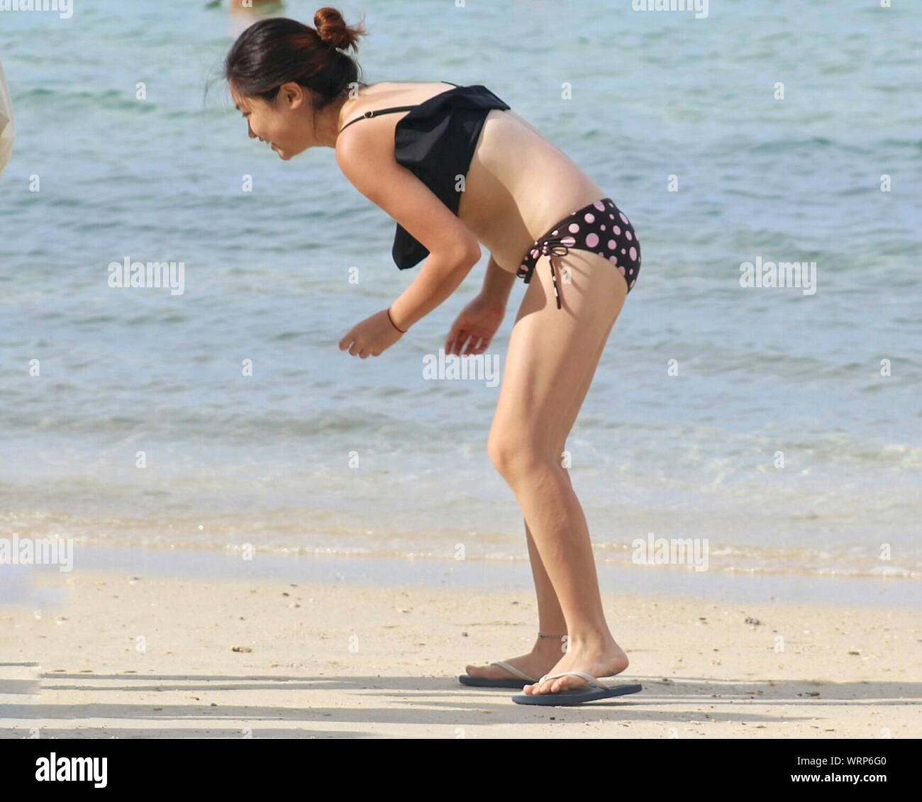Young woman in bikini bending hi-res stock photography and images - Alamy