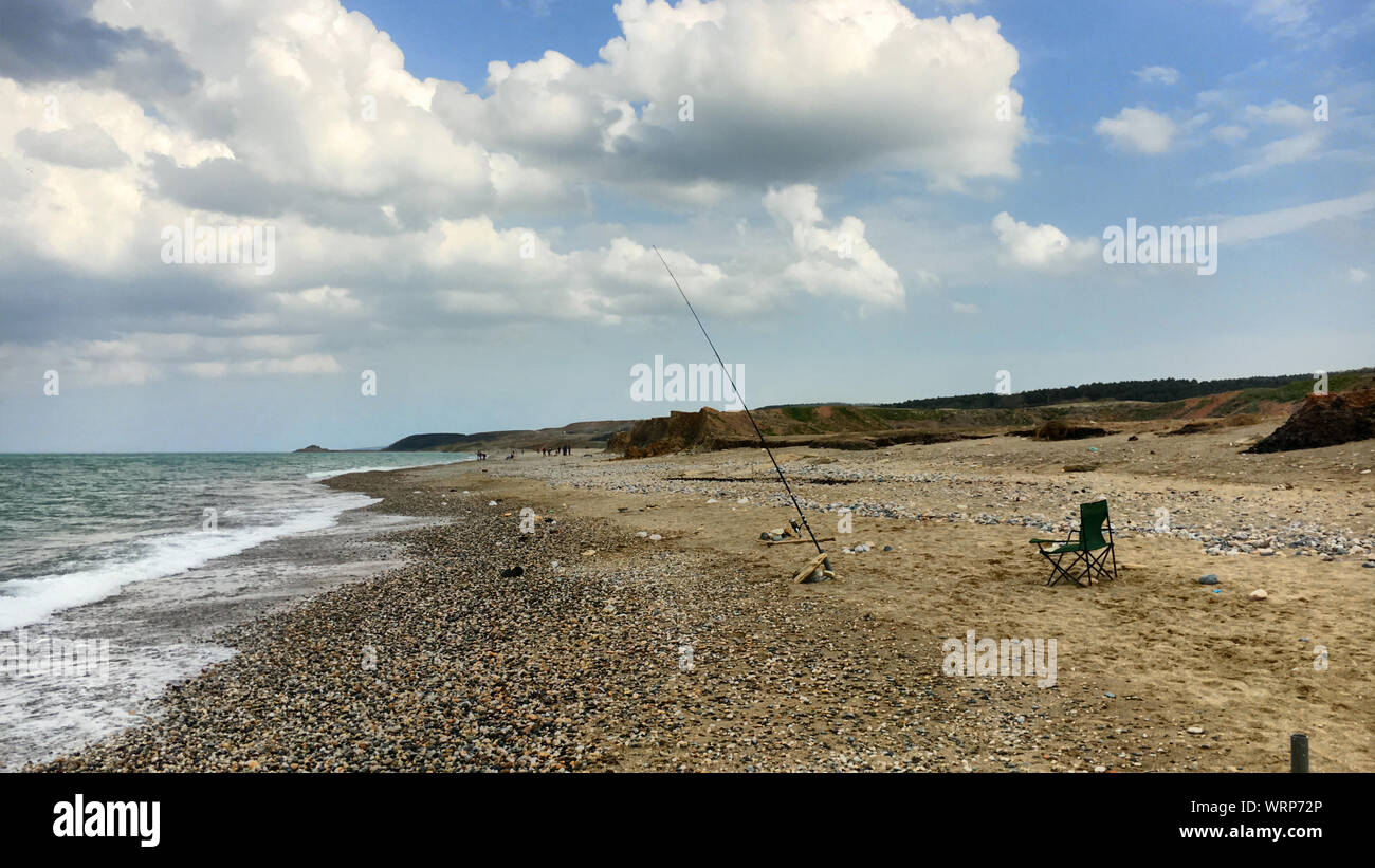 Chair fishing rod on beach hi-res stock photography and images - Alamy