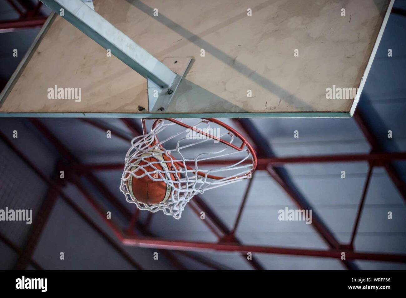 Close-up Of Basketball Hoop With Basketball Stock Photo