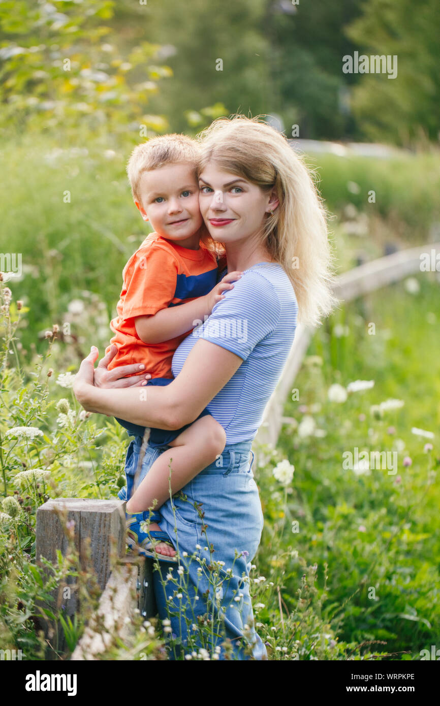 Young Blonde Caucasian Mother And Boy Toddler Son Hugging Kissing In Young Blonde Caucasian Mother And Boy Toddler Son Hugging Kissing In