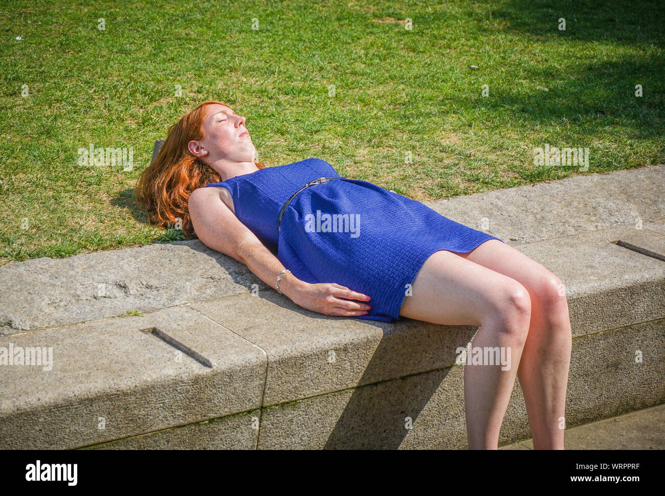 A woman seen sunbathing during a hot day in central London. (Photo by Ioannis Alexopoulos / Alamy ). Stock Photo