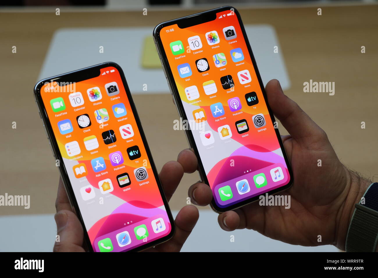 Cupertino, USA. 10th Sep, 2019. A man holds Apple's new smartphone models,  the iPhone 11 Pro (l) and the iPhone 11 Pro Max at the Steve Jobs Theater  on the corporate campus.