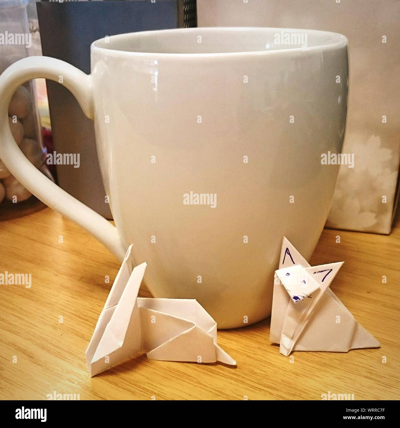 Paper Birds And Coffee Cup On Table Stock Photo
