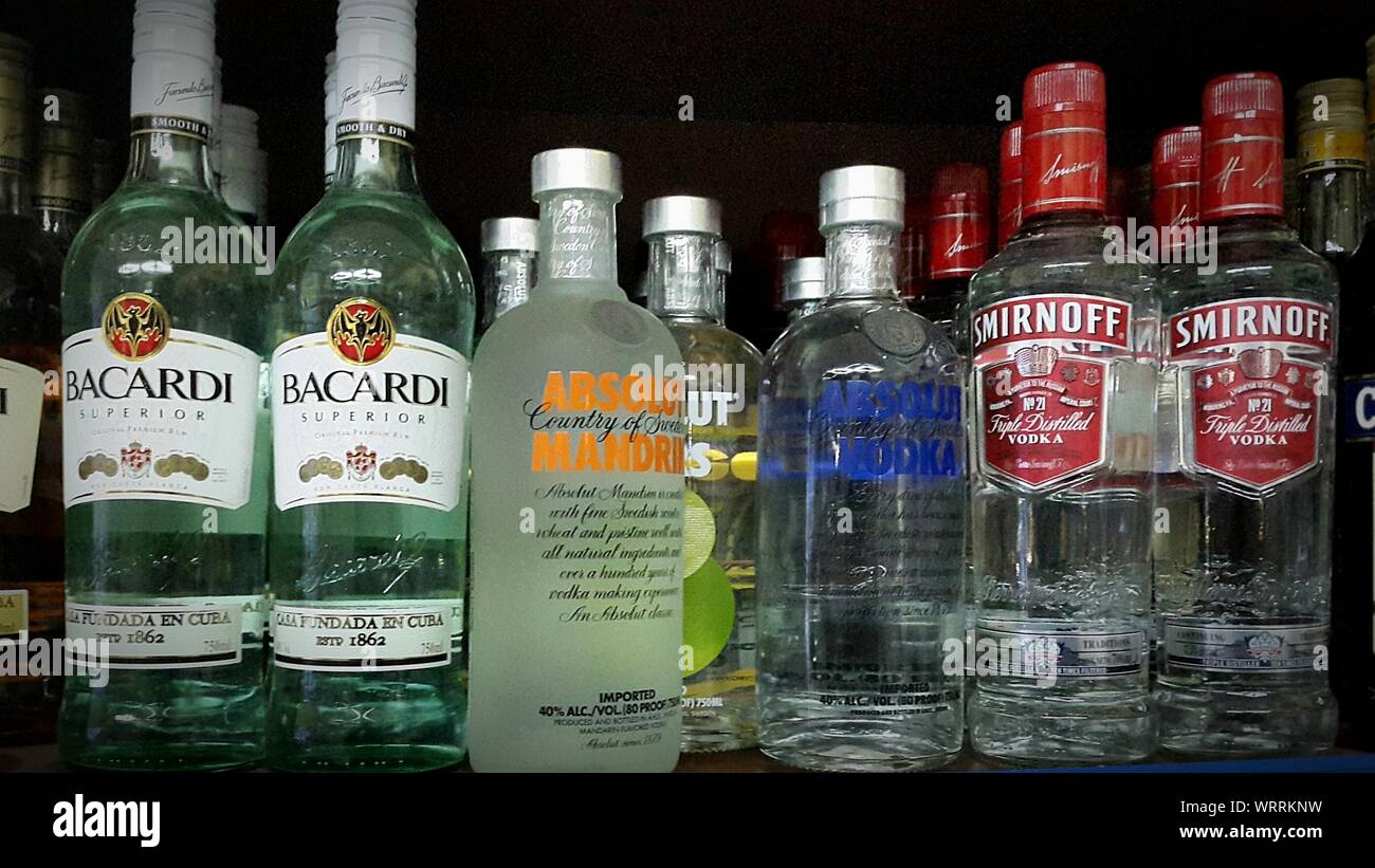 Large Group Of Alcohol Bottle Variations On Counter In Bar Stock Photo