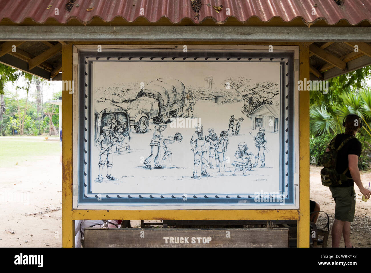 A sign shows the location where prisoners coming in military trucks were unloaded at the Choeung Ek Genocidal Center, outiside Phnom Penh, Cambodia. Stock Photo