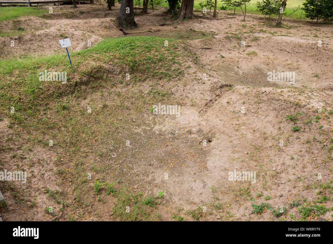 The location of one of the many killing fields mass grave pits at the Choeung Ek Genocidal Center, outiside Phnom Penh, Cambodia. Stock Photo