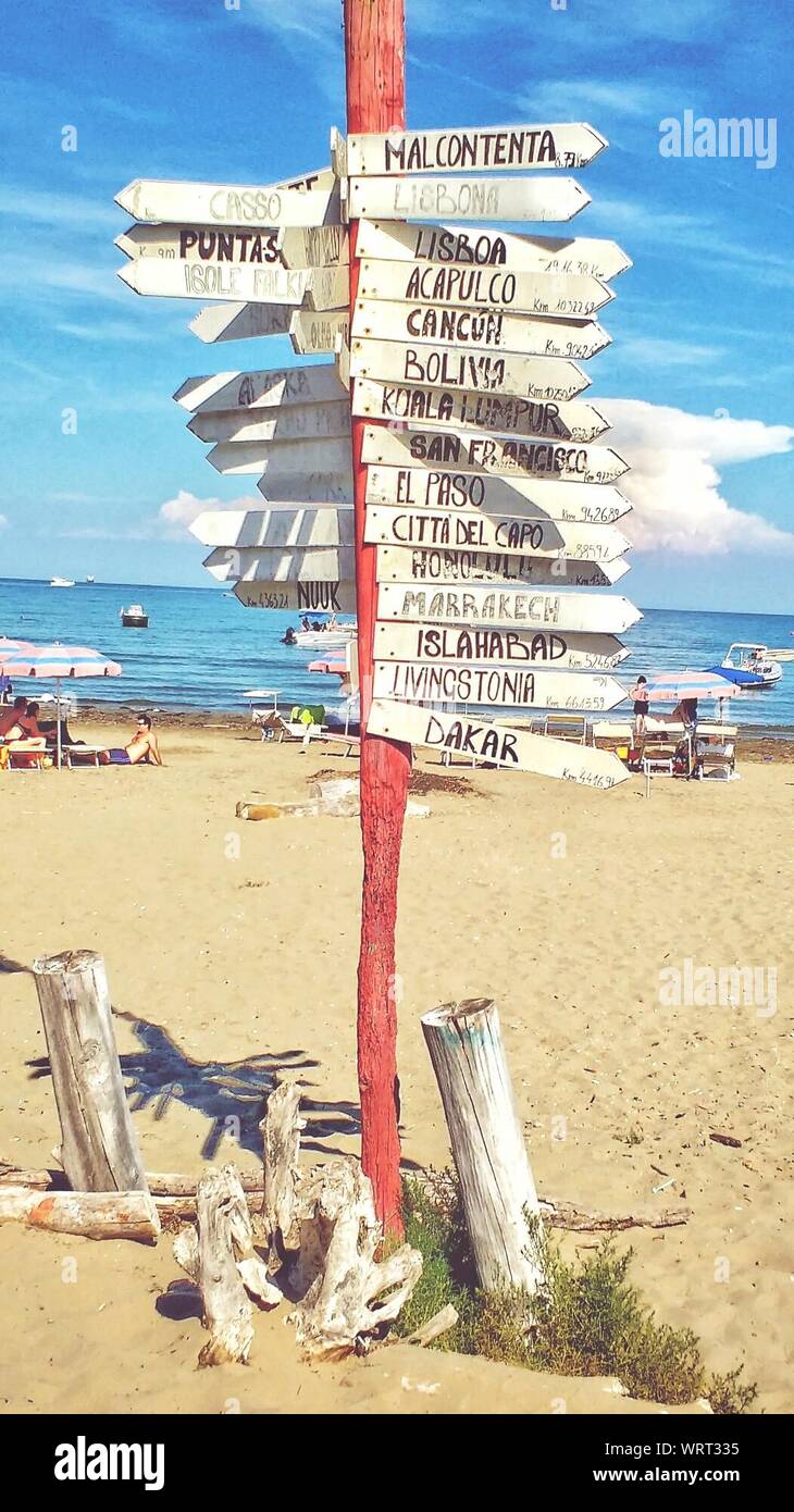 Signs At Beach Against Sky Stock Photo
