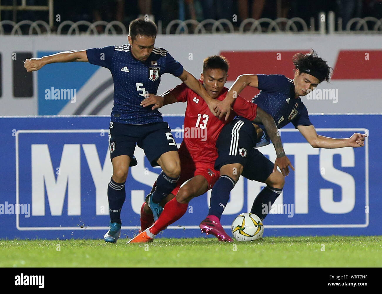 Yangon, Myanmar. 10th Sep, 2019. Kaung Si Thu (C) of Myanmar vies with Yuto Nagatomo (L) and Takumi Minamino of Japan during the FIFA World Cup Qatar 2022 and AFC Asian Cup China 2023 Preliminary Joint Qualification second round group F football match between Myanmar and Japan in Yangon, Myanmar, Sept. 10, 2019. Credit: U Aung/Xinhua Stock Photo