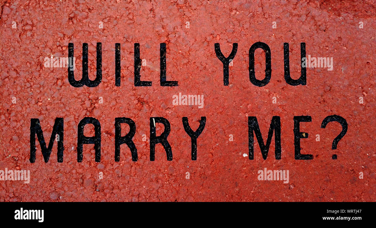 'Will You Marry Me? Etched into Red Brick Background Stock Photo