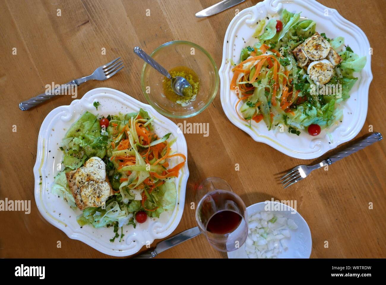 High Angle View Of Salads With Crouton And Wine On Table At Home Stock Photo