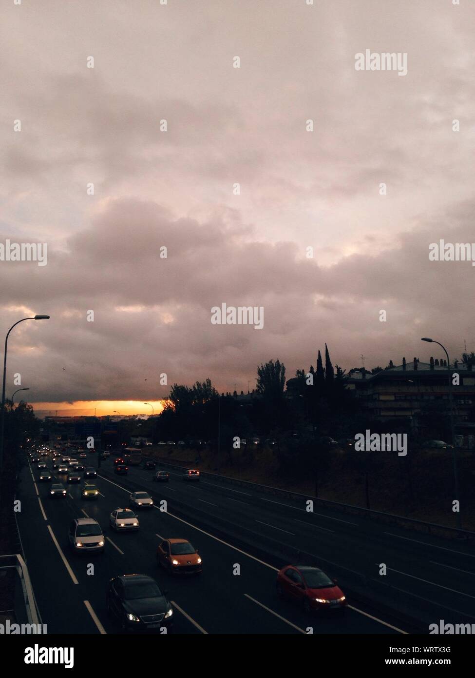 Elevated View Of Road And Oncoming Traffic At Dusk Stock Photo