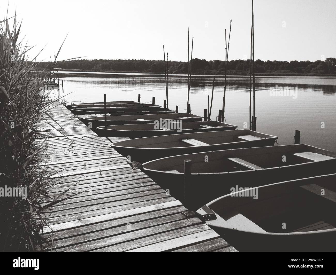 Boats Moored By Pier At Lake Stock Photo - Alamy