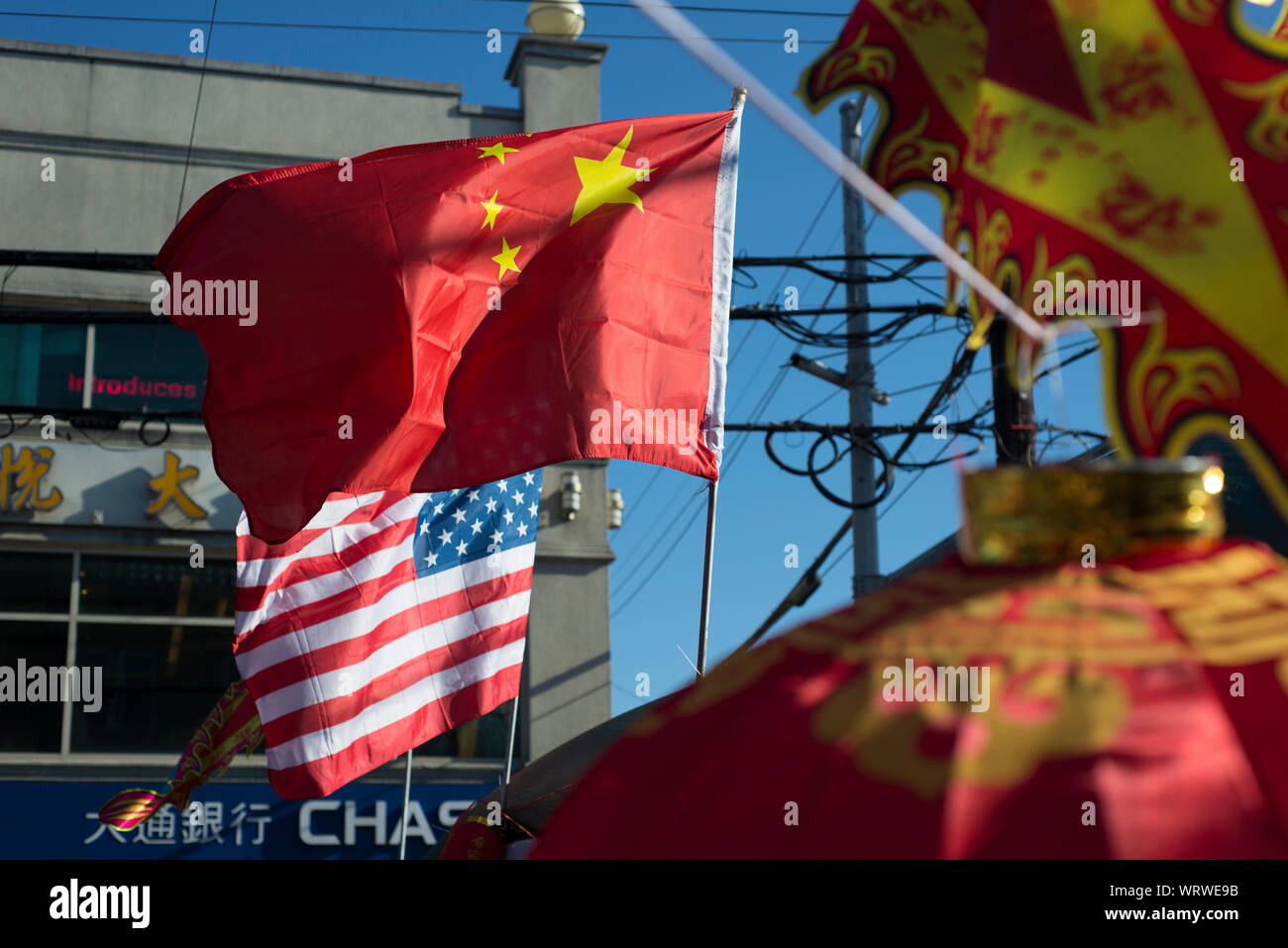 Chinese and American flags on 8th Avenue in the Brooklyn, New York Chinatown. Stock Photo