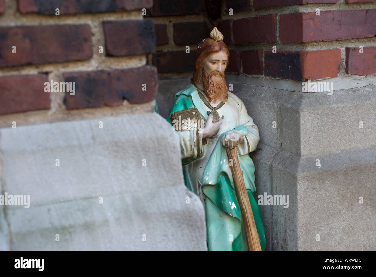 A small statue of Jesus Christ situated in a corner of a Catholic