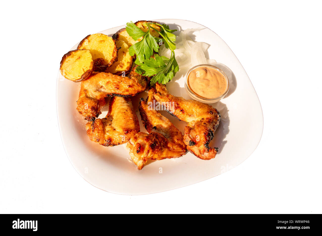 fried chicken wings on a plate with a side dish of fried potatoes and