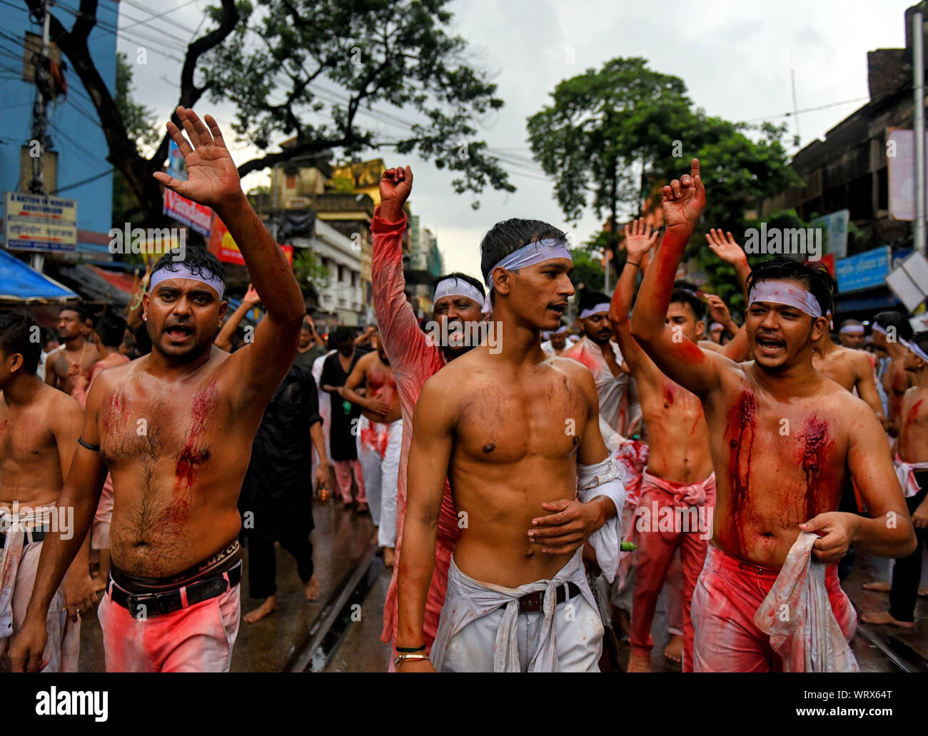 Kolkata, India. 10th Sep, 2019. (EDITOR'S NOTE: Image contains graphics.)Shi'ite Muslims beat their chests and heads with blades & swords during the Muharram procession of Kolkata. Muharram is the first month of the Islamic calendar & Ashura is the tenth day of the month of Muharram on which the commemoration of the martyrdom of Imam Hussain, the grandson of Prophet Muhammad (PBUH), during the battle of Karbala, is done. Credit: SOPA Images Limited/Alamy Live News Stock Photo
