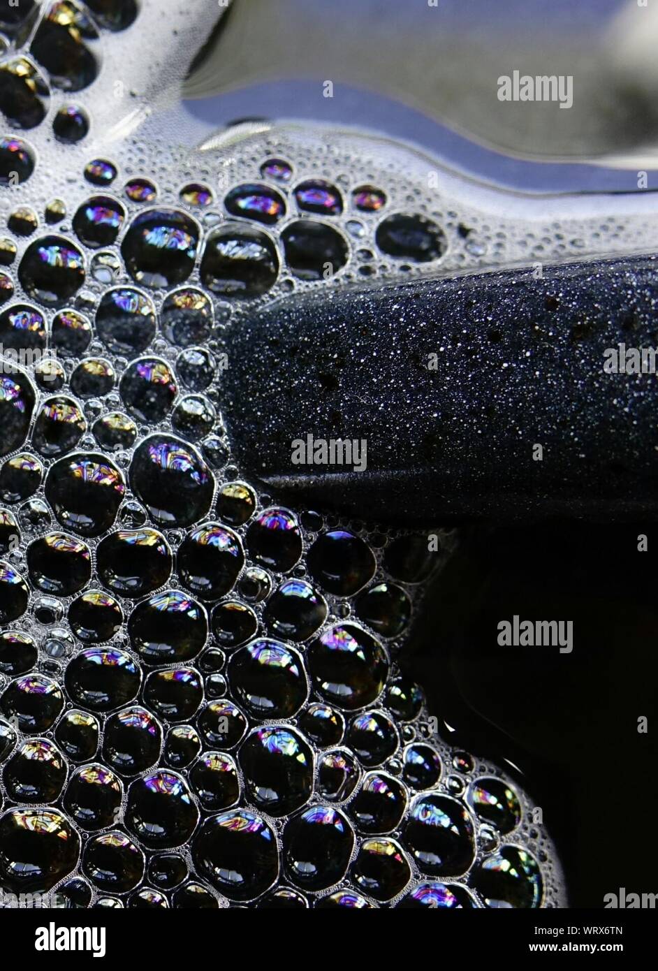 Close Up Of Soap Bubbles On Dishes In Sink Stock Photo Alamy