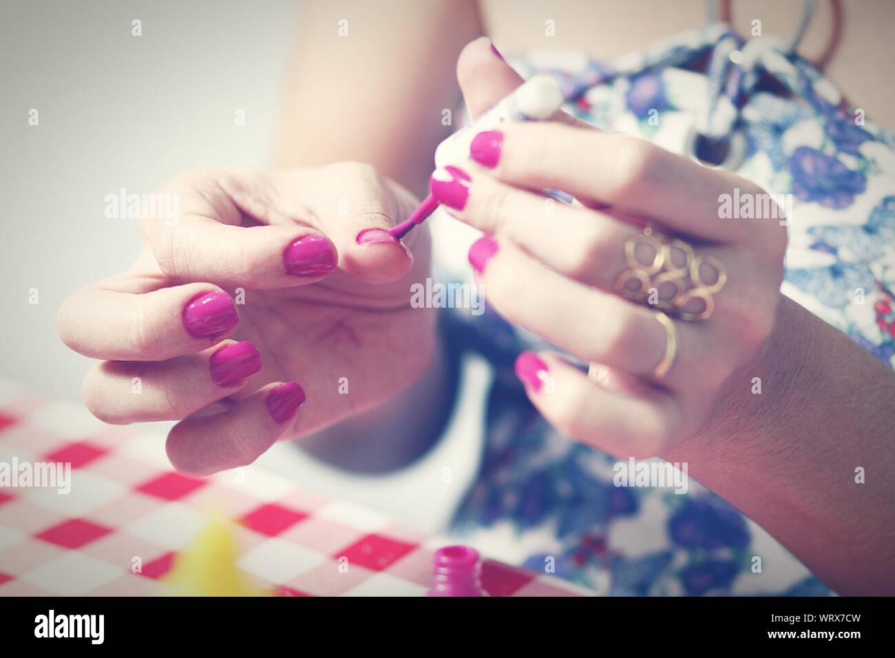 Midsection Of Woman Painting Fingernails Stock Photo