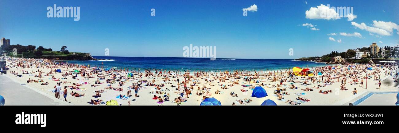 Panoramic View Of People At Coogee Beach Against Sky Stock Photo