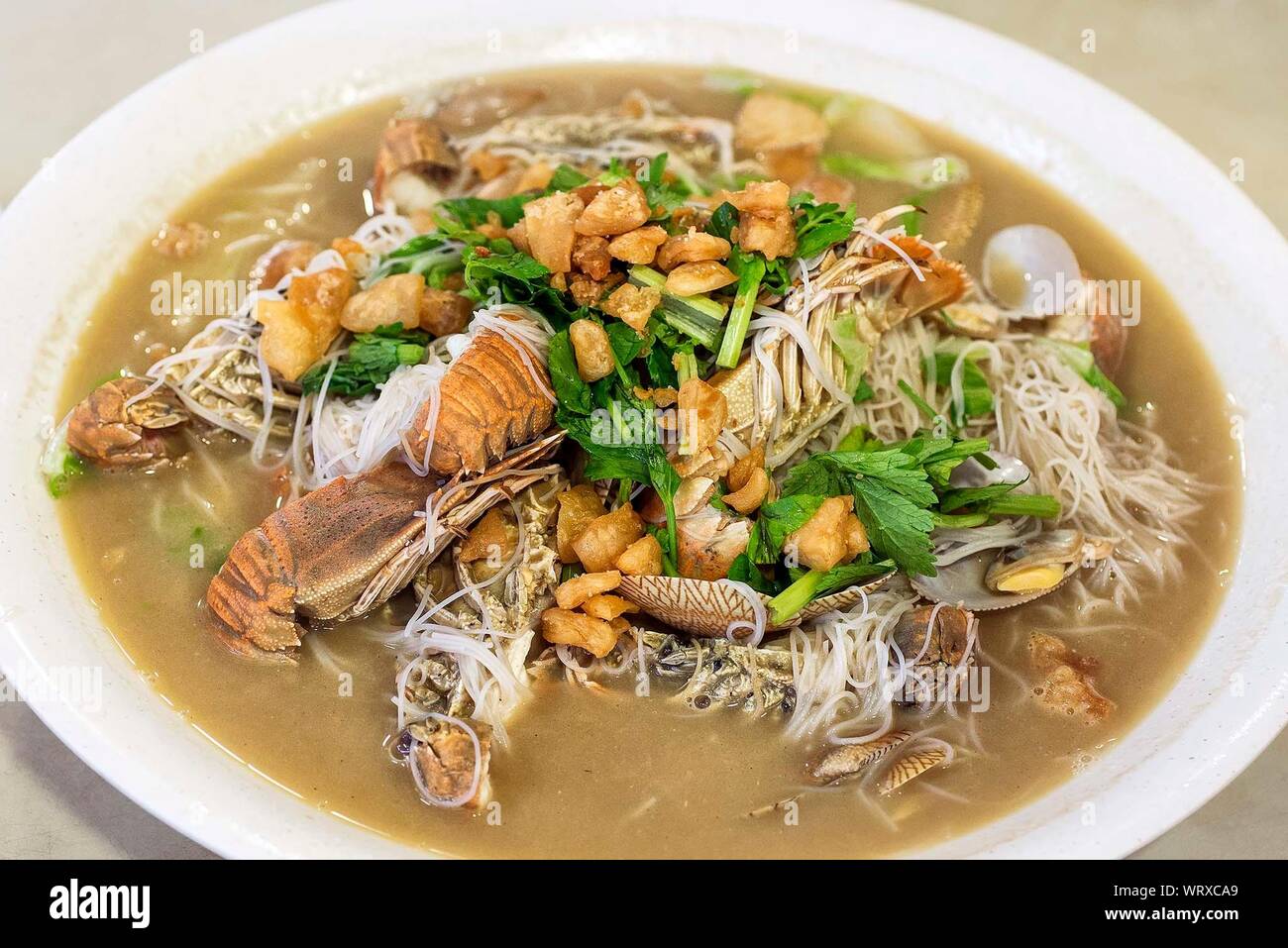 High Angle View Of Seafood With Rice Noodles In Bowl On Table Stock Photo
