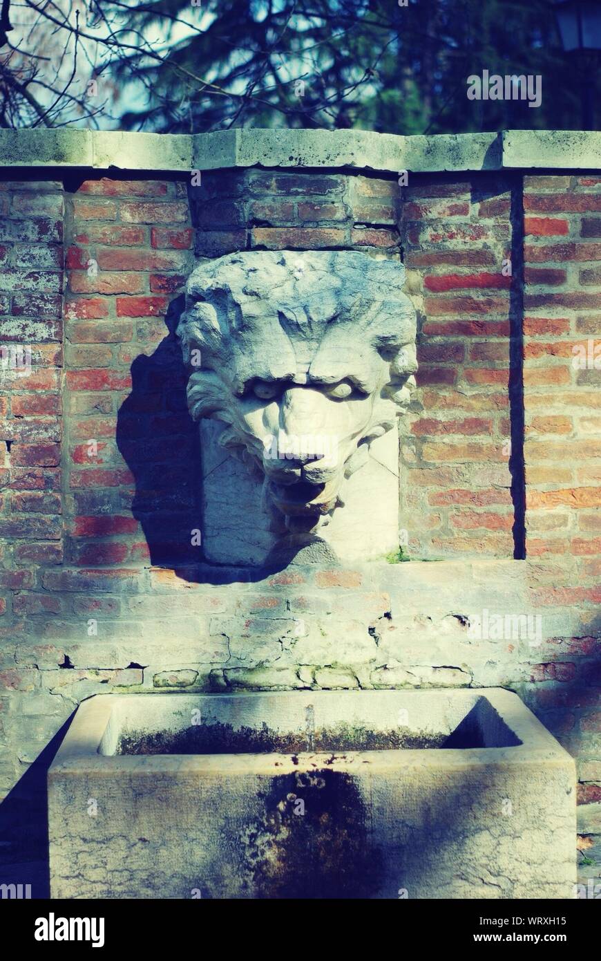Sculpted Fountain On Brick Wall Stock Photo Alamy