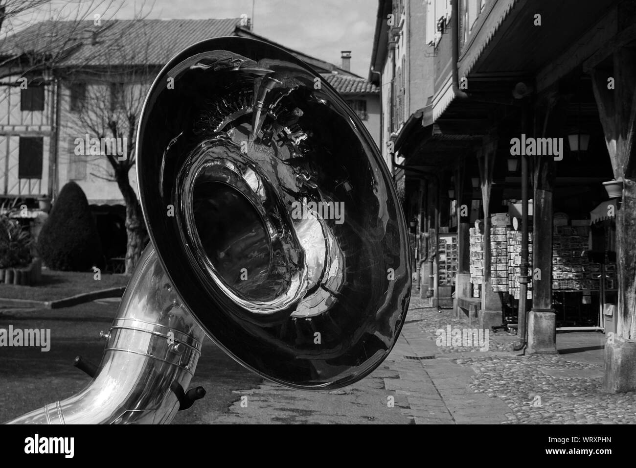 Close-up Of Brass Instrument On Street Against Buildings Stock Photo