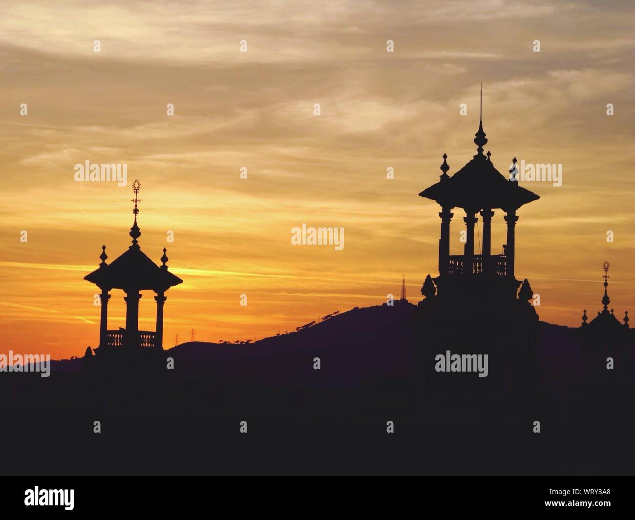 Silhouette Traditional Architectures Against Cloudy Sky During Sunset Stock Photo