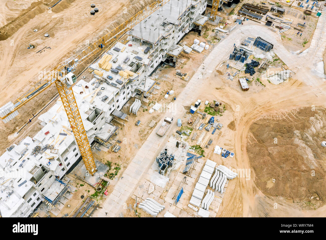 aerial top view of apartment building under construction with working machinery Stock Photo