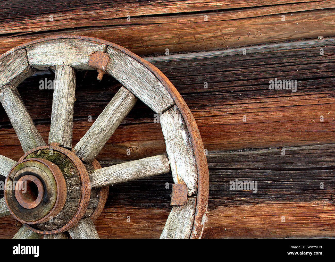 Close-up Of Wooden Wheel On Wall Stock Photo