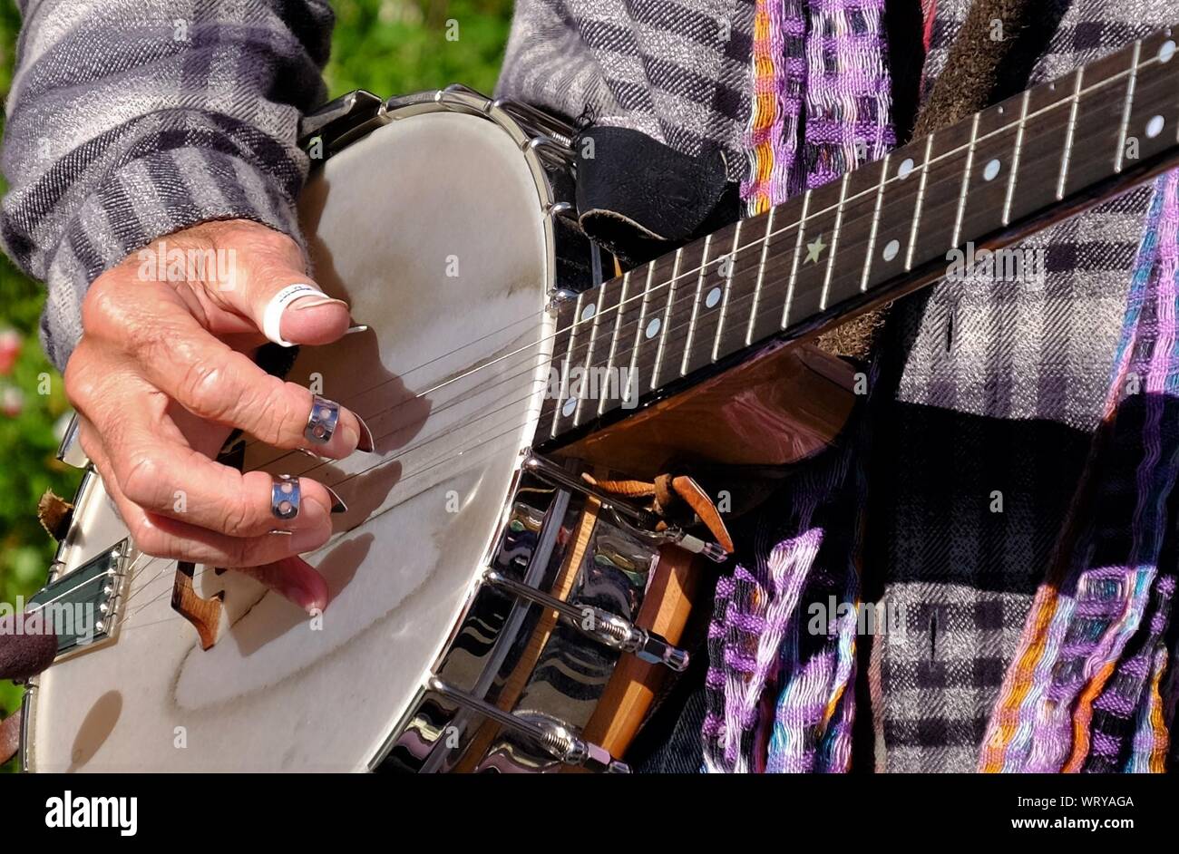 Midsection Of Man Playing Banjo With Fingerpicks Stock Photo