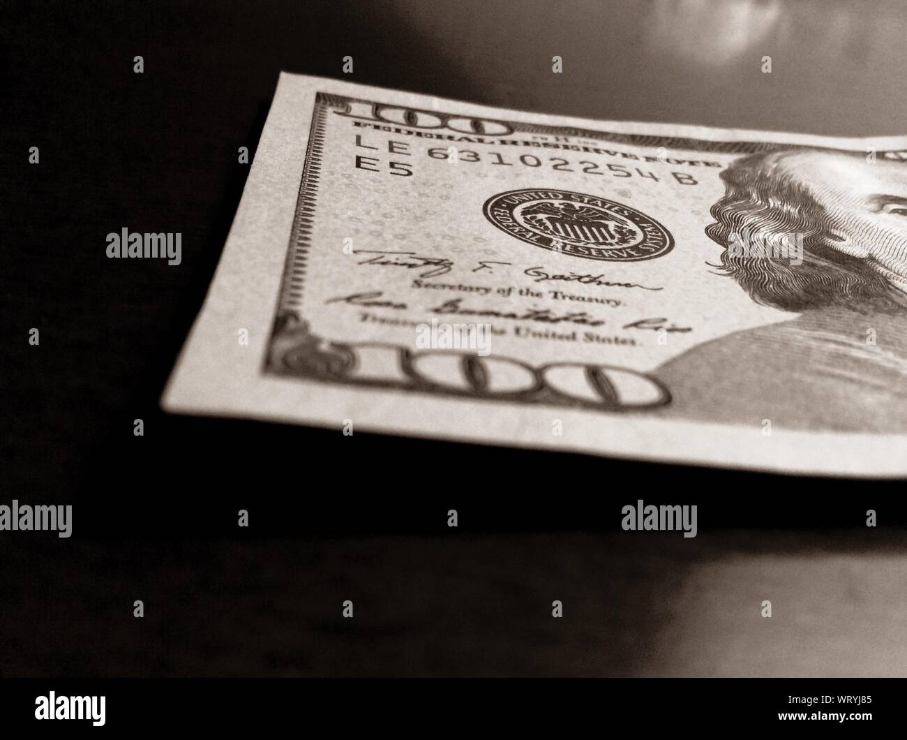 Close-up Of American One Hundred Dollar Bill On Table Stock Photo