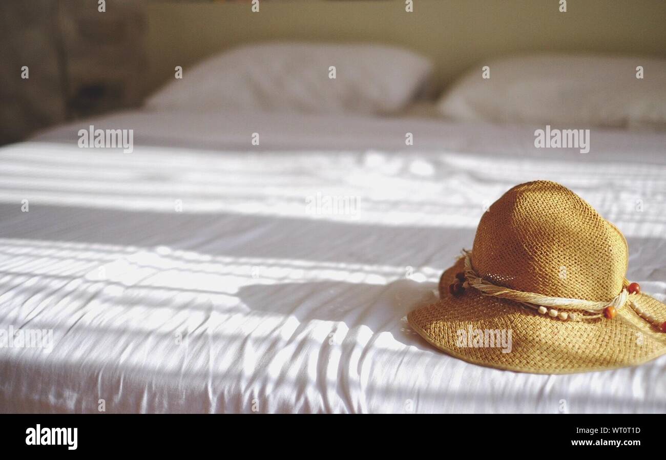Hat On Bed During Sunny Day Stock Photo