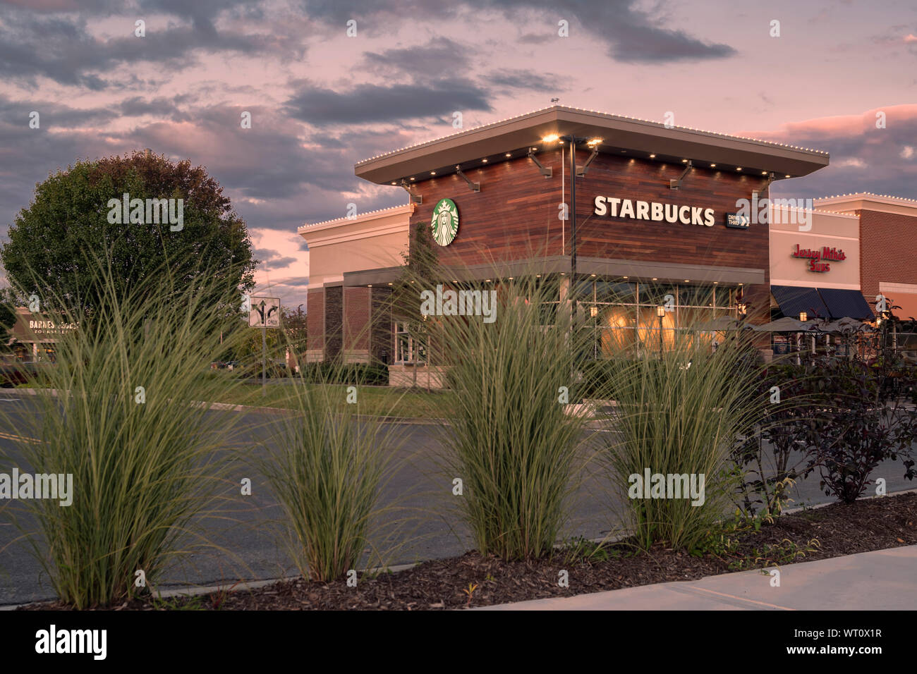 New Hartford, NY - SEPTEMBER 09, 2019: Exterior Night View of Starbucks Coffee, which is an American chain of coffee shops, founded in Seattle. Stock Photo