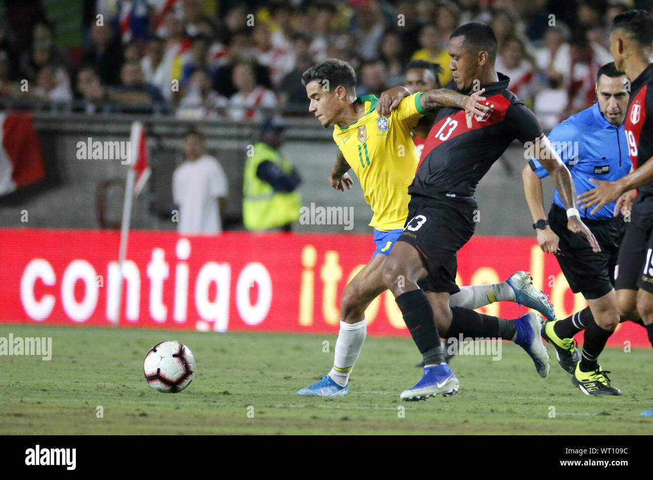 Los Angeles, California, USA. 10th Sep, 2019. Brazil midfielder Philippe Coutinho (11) and Peru midfielder Renato Tapia (13) vie for the ball during an International Friendly Soccer match between Brazil and Peru at the Los Angeles Memorial Coliseum in Los Angeles on Tuesday, September 10, 2019. Credit: Ringo Chiu/ZUMA Wire/Alamy Live News Stock Photo
