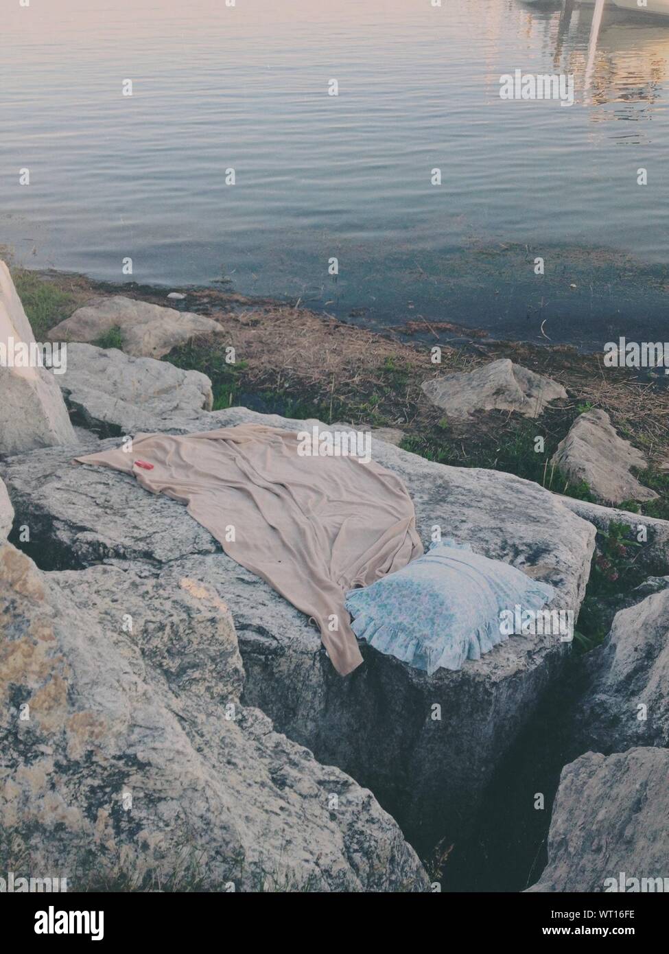 Abandoned Blouse And Pillow On Boulder Stock Photo