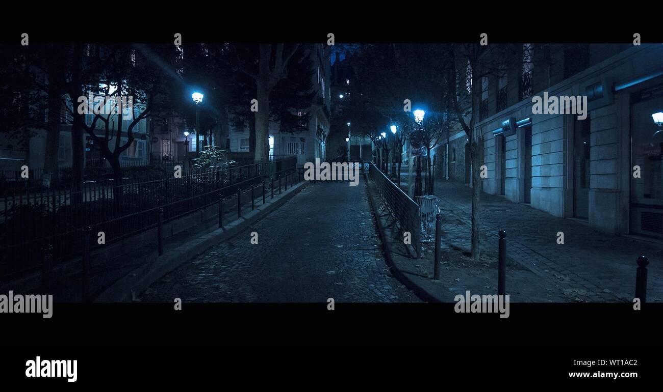 Illuminated Lampposts In Street Stock Photo