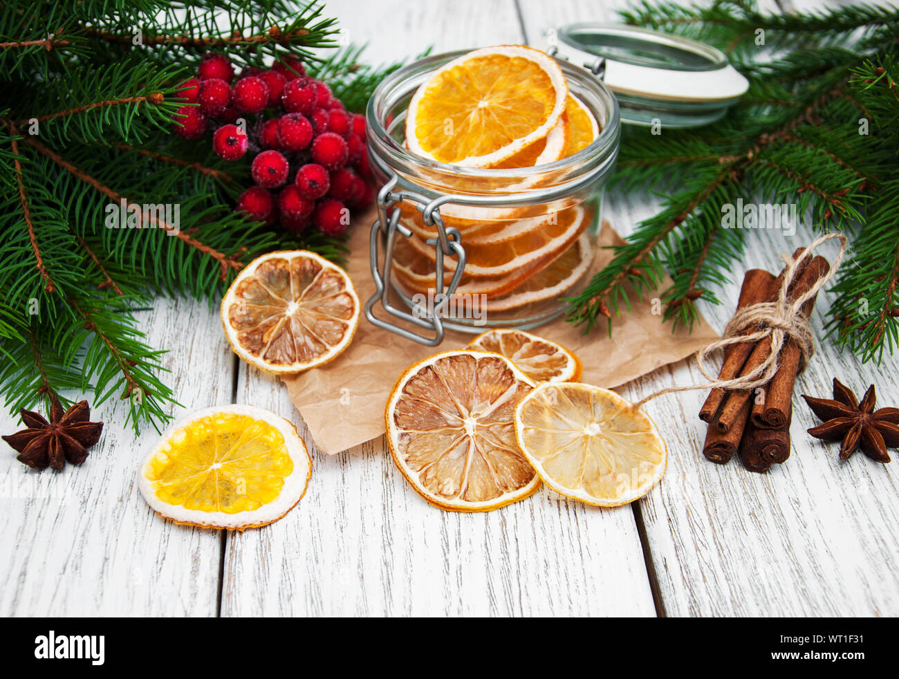 Jar With Dried Oranges And Christmas Decorations Stock Photo