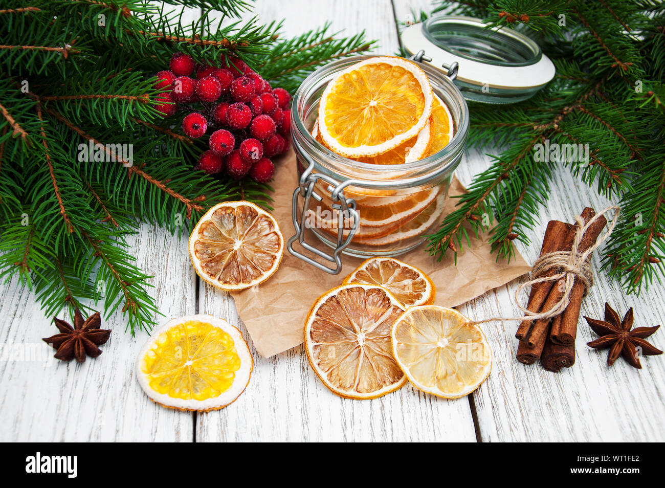 Jar With Dried Oranges And Christmas Decorations Stock Photo