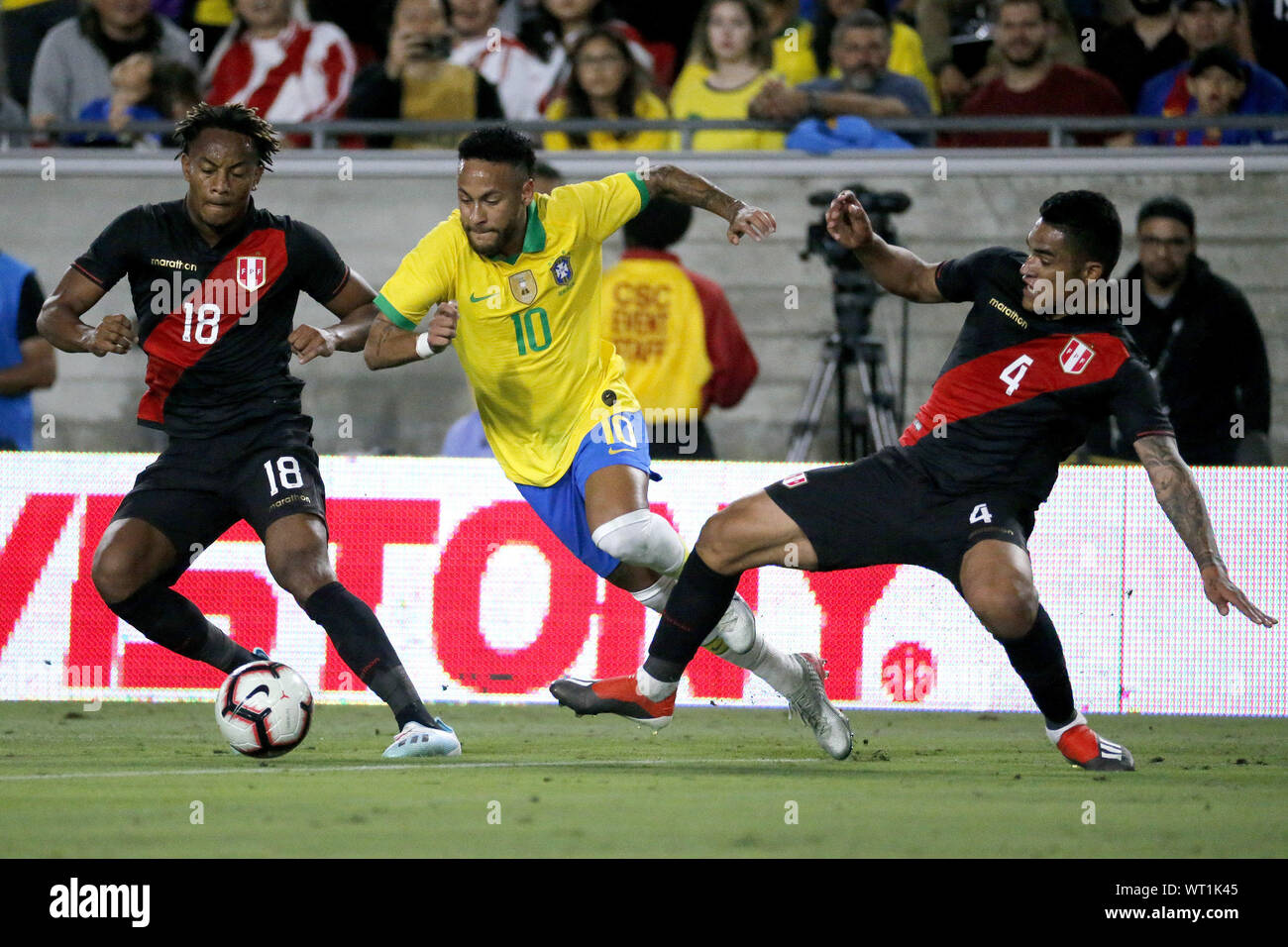 Los Angeles, California, USA. 10th Sep, 2019. Brazil forward Neymar Jr. (10) drives past Peru defender Anderson Santamaria (4) and Peru midfielder Andre Carrillo (18) during an International Friendly Soccer match between Brazil and Peru at the Los Angeles Memorial Coliseum in Los Angeles on Tuesday, September 10, 2019. Credit: Ringo Chiu/ZUMA Wire/Alamy Live News Stock Photo