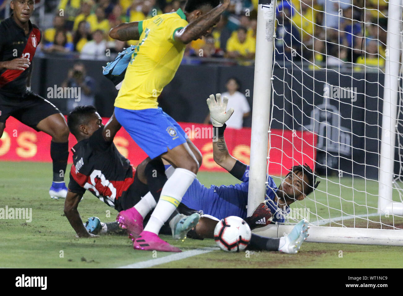 September 10, 2019, Los Angeles, California, U.S: Peru goalkeeper Pedro Gallese (1) and Peru midfielder Pedro Aquino (23) make save against Brazil defender Eder Militao (3) during an International Friendly Soccer match between Brazil and Peru at the Los Angeles Memorial Coliseum in Los Angeles on Tuesday, September 10, 2019. (Credit Image: © Ringo Chiu/ZUMA Wire) Stock Photo